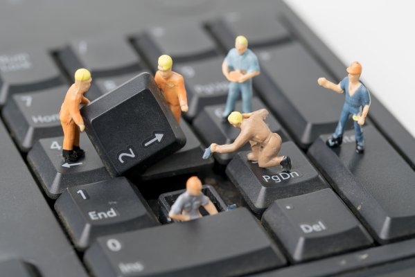 regclean pro registry cleaners features tiny working men figurines toys working on computer keyboard